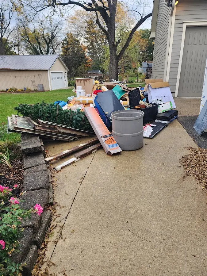 Dumpster being loaded with debris for 12 Yard Dumpster Rental in Hagar